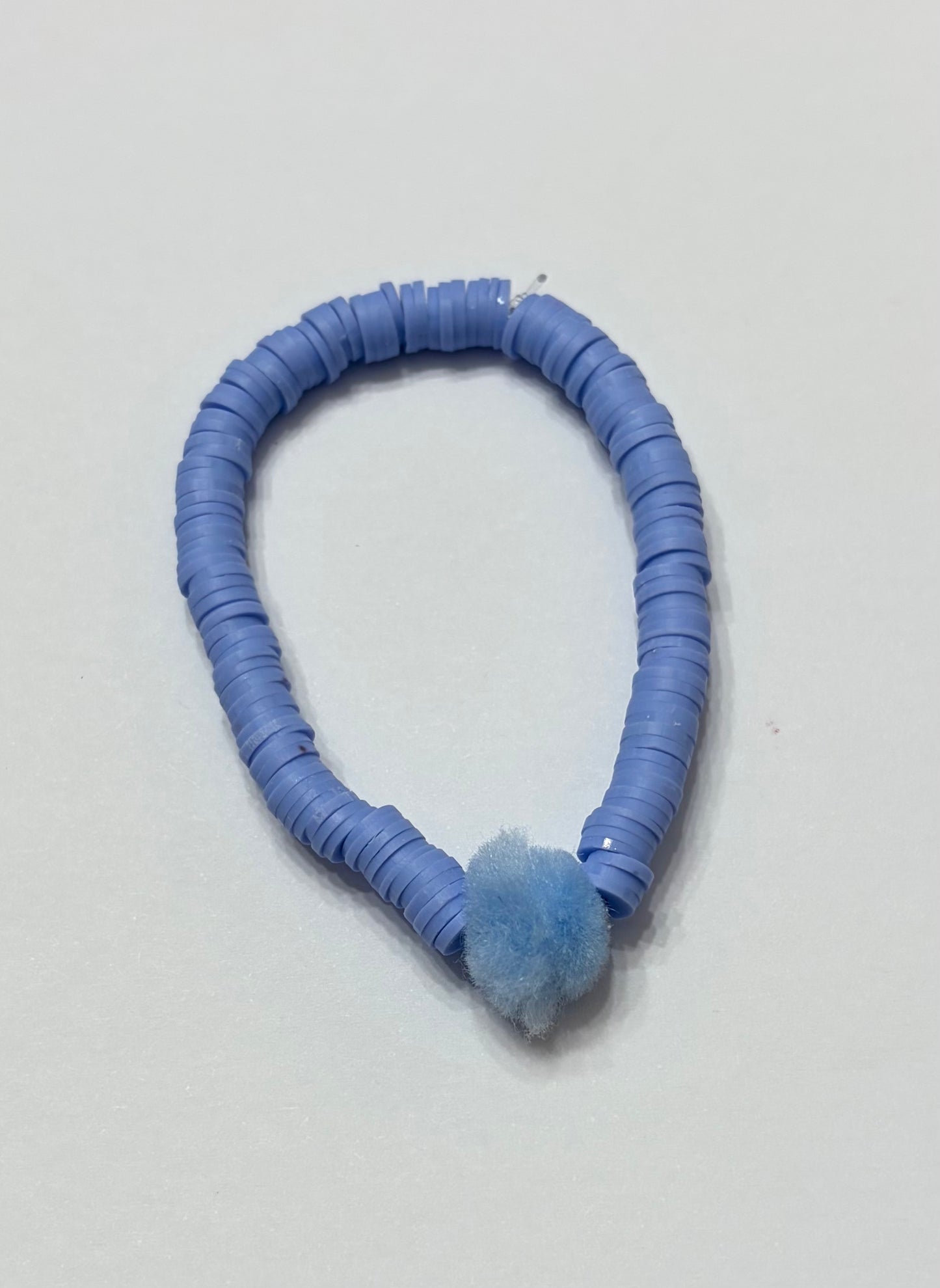 Blue clay beads with light blue soft pom-pom