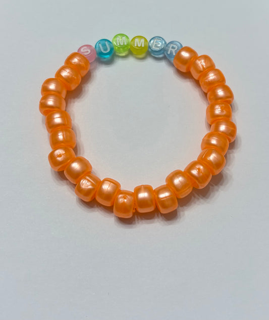 Shiny orange pony beads with the word summer in the middle