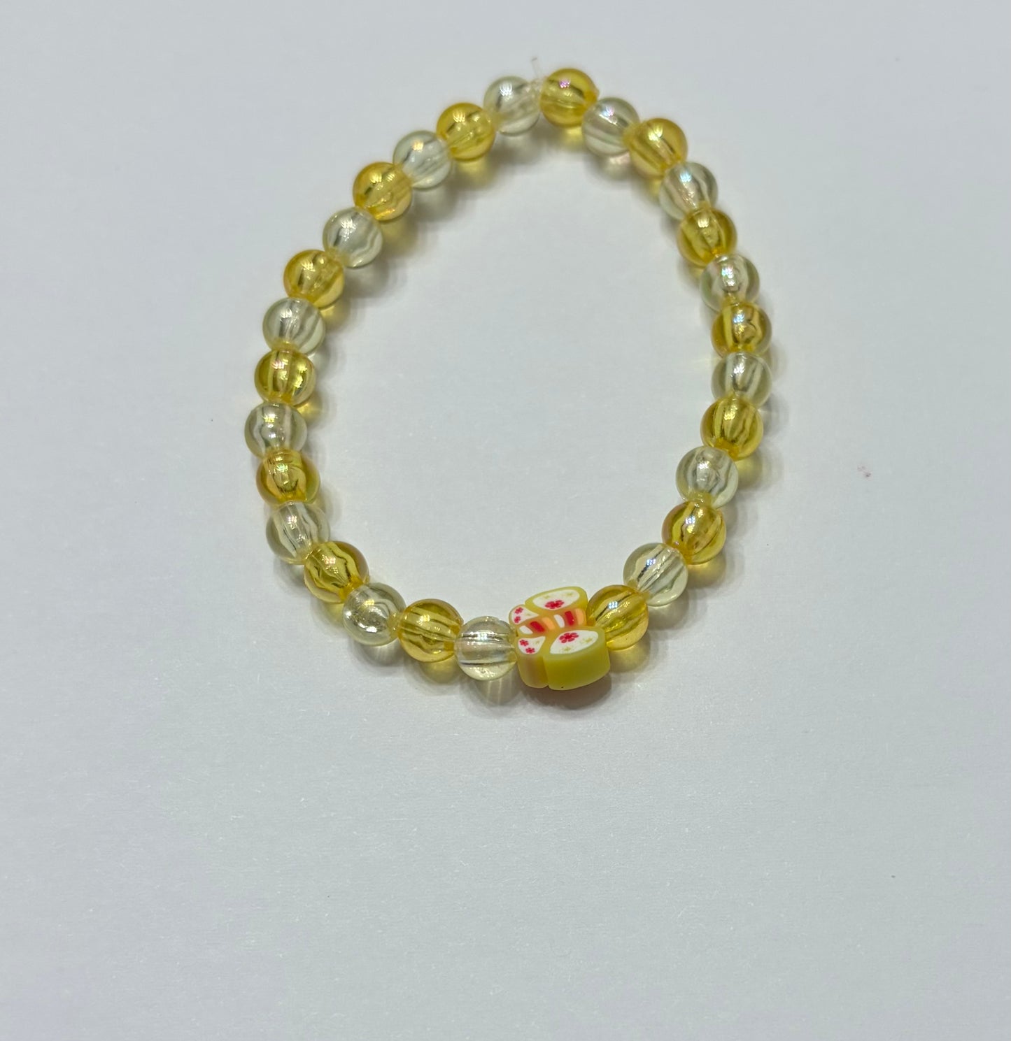 Yellow beads with a yellow butterfly bead in the middle