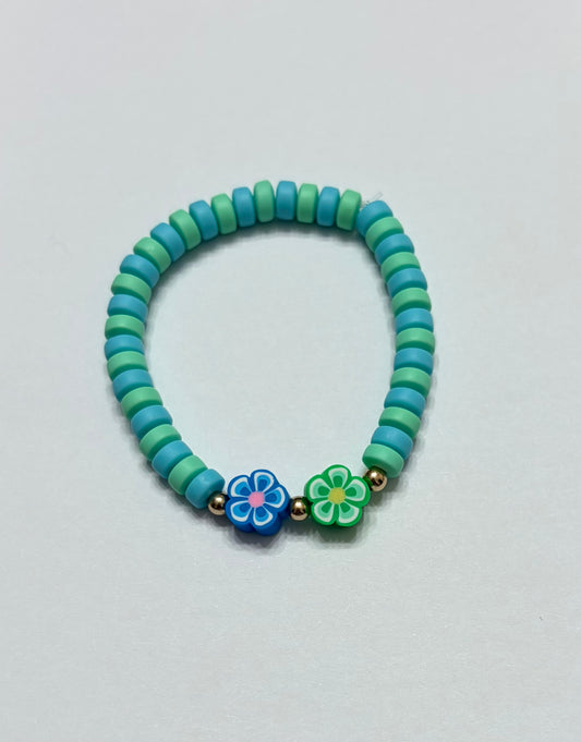 Teal green and blue beads with gold beads in between the green and blue aloha flowers