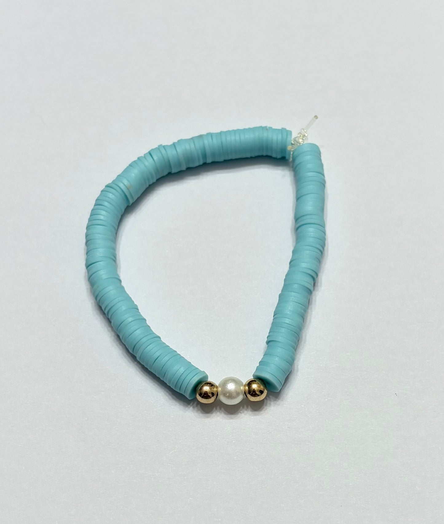 Blue clay beads with gold beads in between the pearl bead