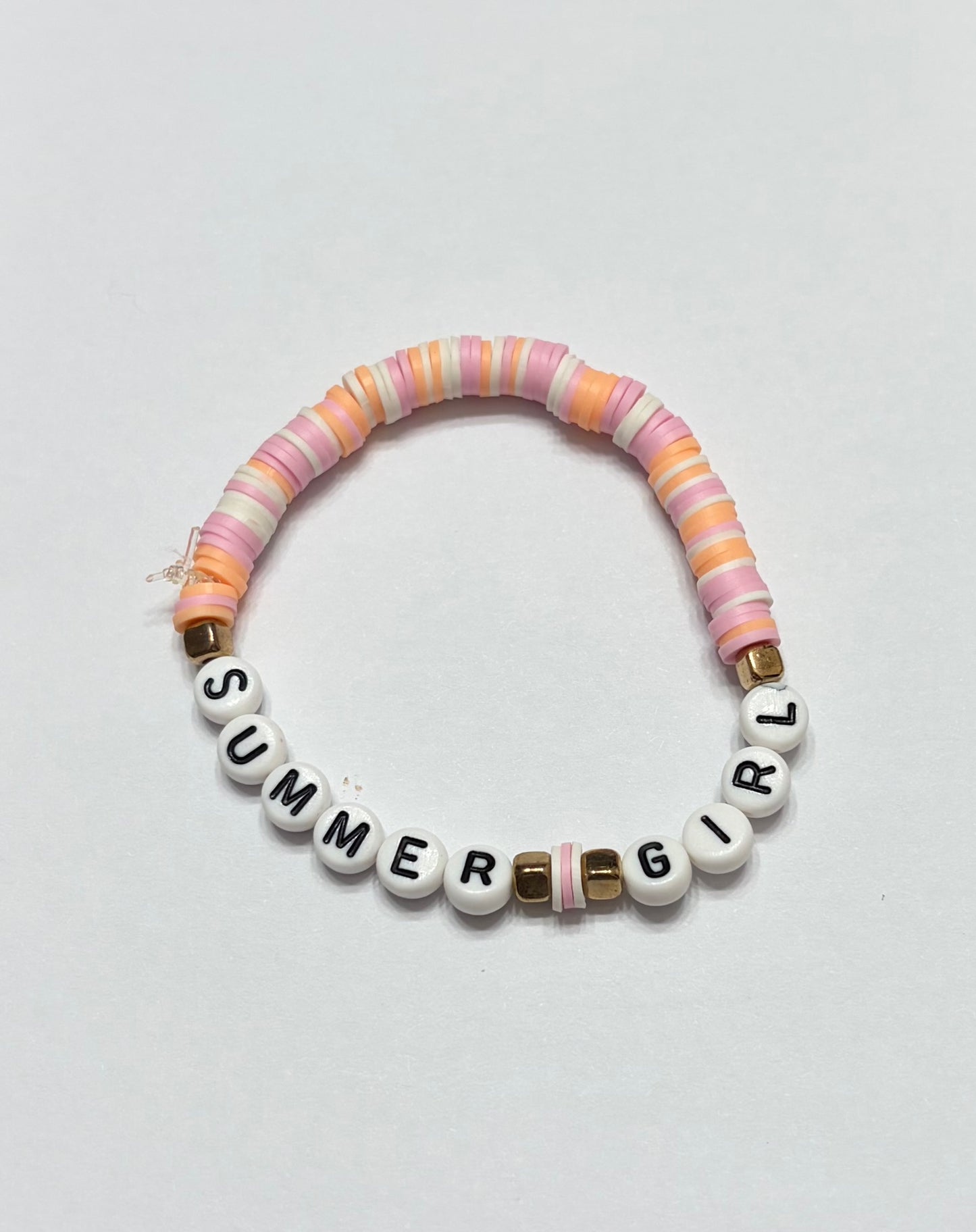 Pink orange and white clay beads with rectangular gold spacers in between summer girl