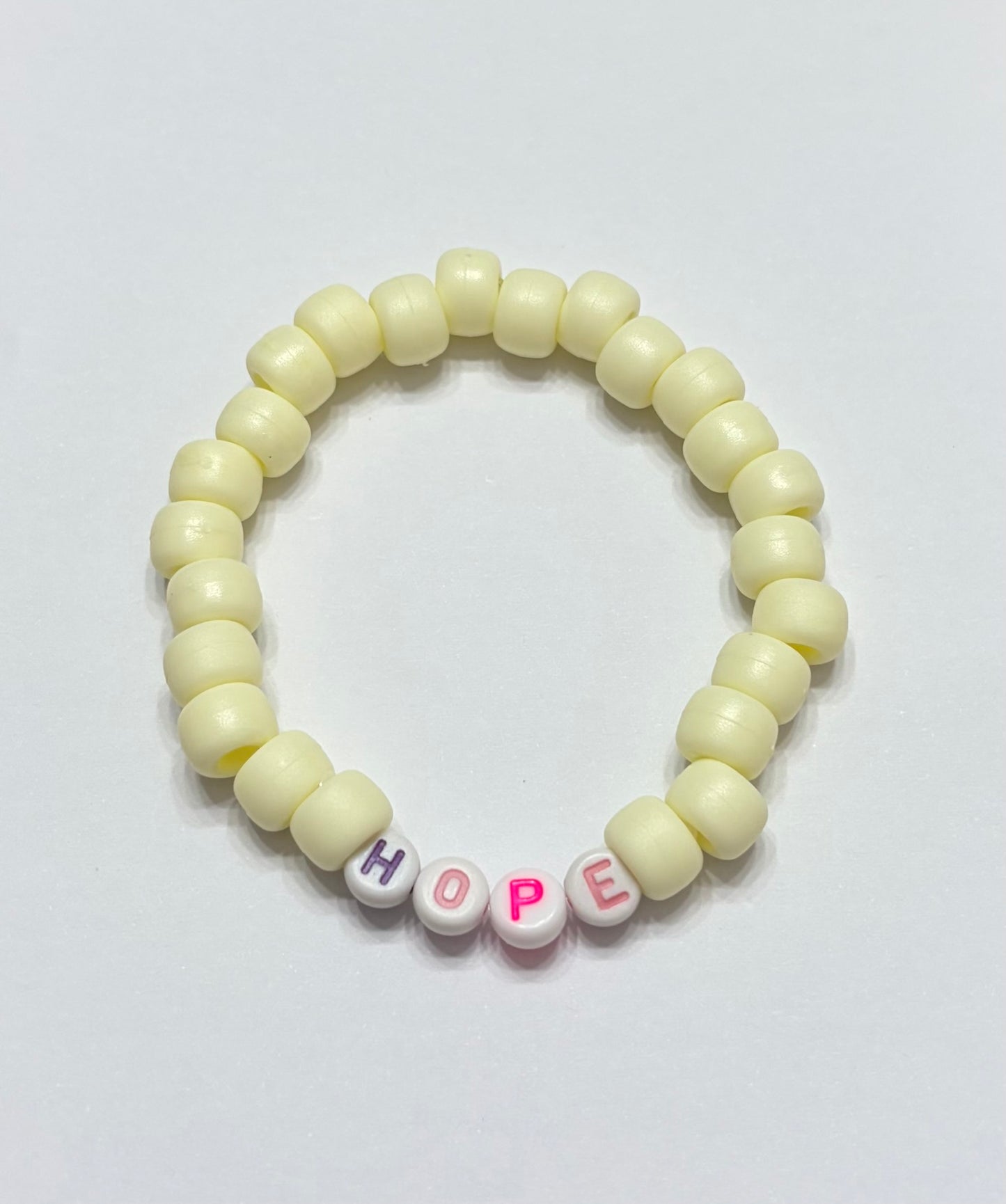 Light yellow pony beads with the word hope
