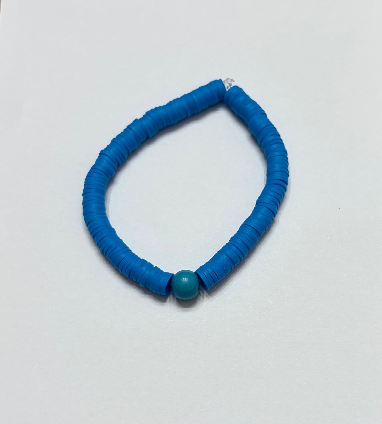 Blue clay beads with blue charm in the middle