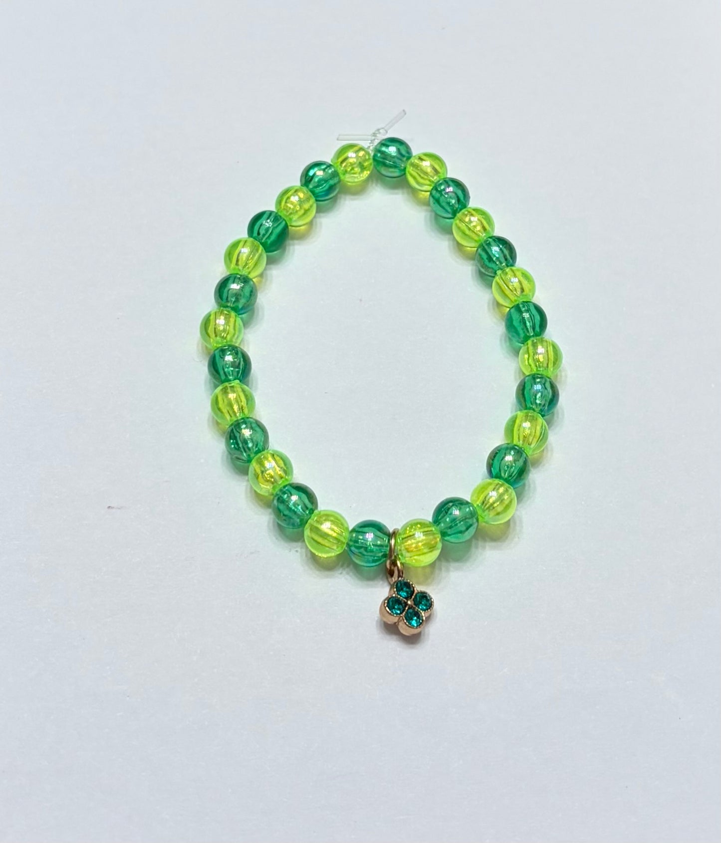 Dark green, light green, and green charm in the middle